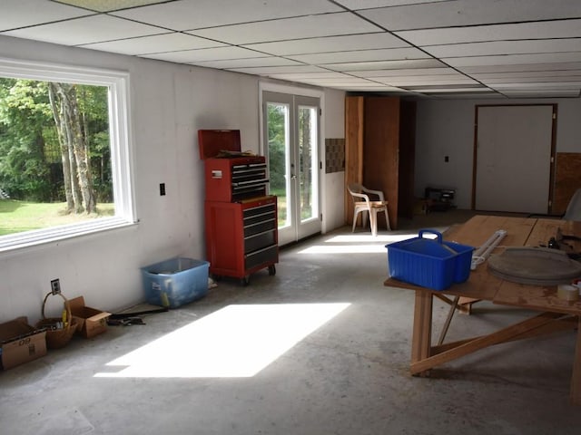 miscellaneous room featuring a healthy amount of sunlight, french doors, and a drop ceiling