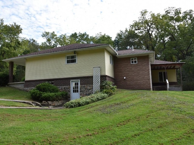 view of side of home with a lawn