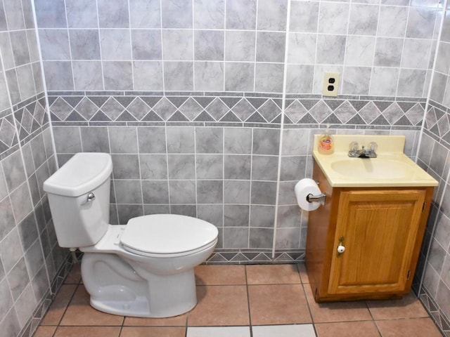 bathroom with tile patterned floors, vanity, and tile walls