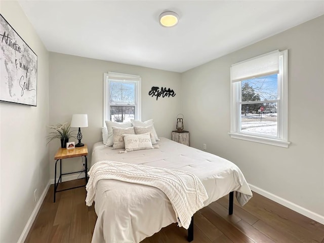 bedroom featuring baseboards and wood finished floors