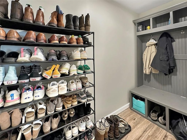 mudroom with wood finished floors and baseboards