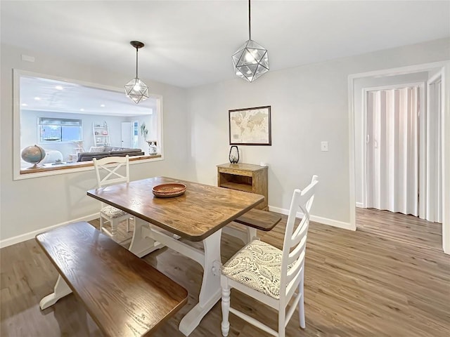 dining room with recessed lighting, baseboards, and wood finished floors