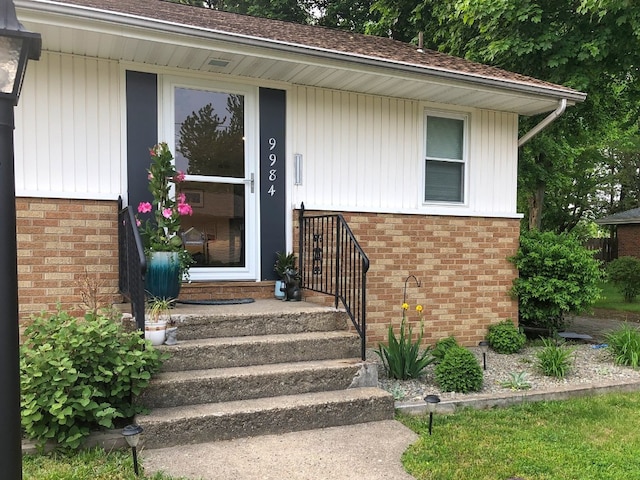 property entrance with brick siding