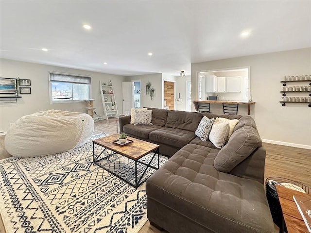 living area featuring recessed lighting, wood finished floors, and baseboards