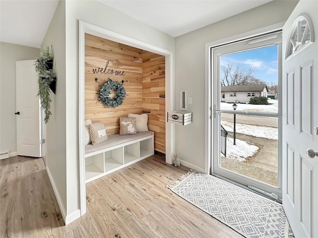 mudroom featuring light wood-style flooring and baseboards