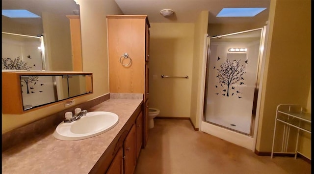 bathroom with vanity, toilet, and a shower with door