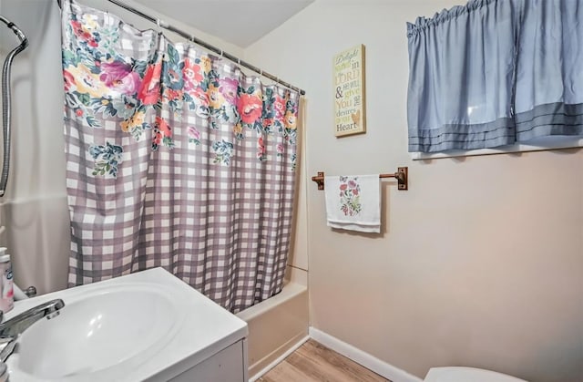 406 Spring St, Jamestown, PA 16134 - bathroom with wood finished floors, shower / bath combination with curtain, baseboards, toilet, and vanity