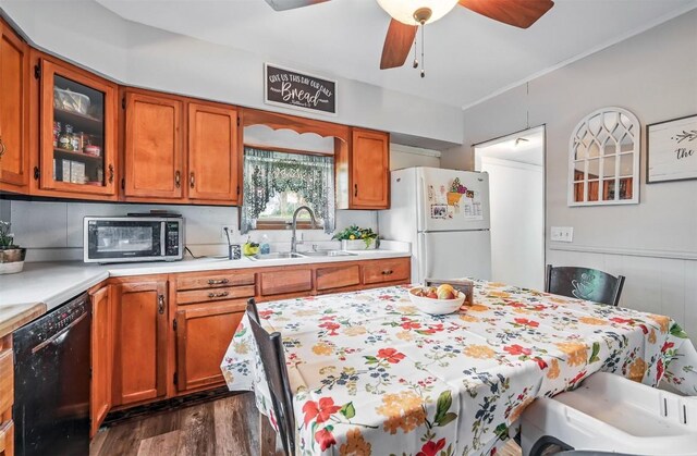 406 Spring St, Jamestown, PA 16134 - kitchen with dishwasher, a sink, freestanding refrigerator, light countertops, and dark wood-type flooring