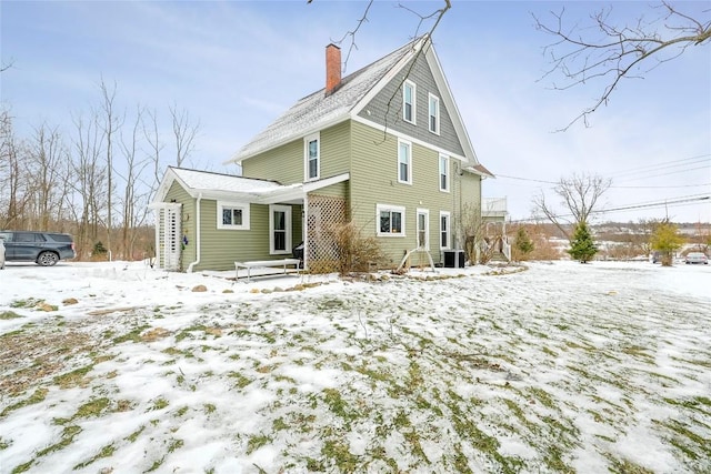 snow covered property with central AC