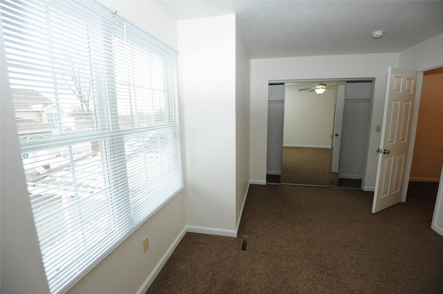 hallway featuring dark carpet