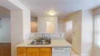 kitchen featuring sink and white dishwasher