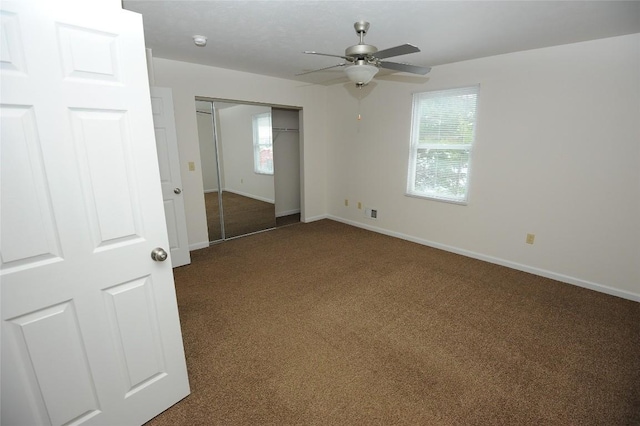 unfurnished bedroom with carpet flooring, a closet, and ceiling fan