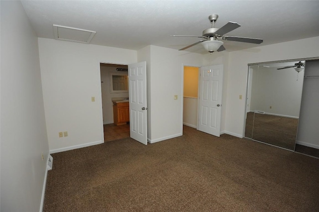 unfurnished bedroom with dark colored carpet, a closet, and ceiling fan