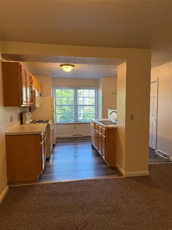 kitchen featuring stove, stainless steel dishwasher, and sink