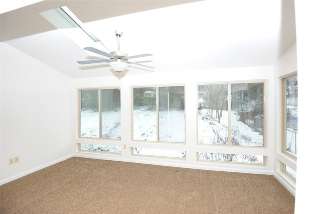 unfurnished sunroom with ceiling fan