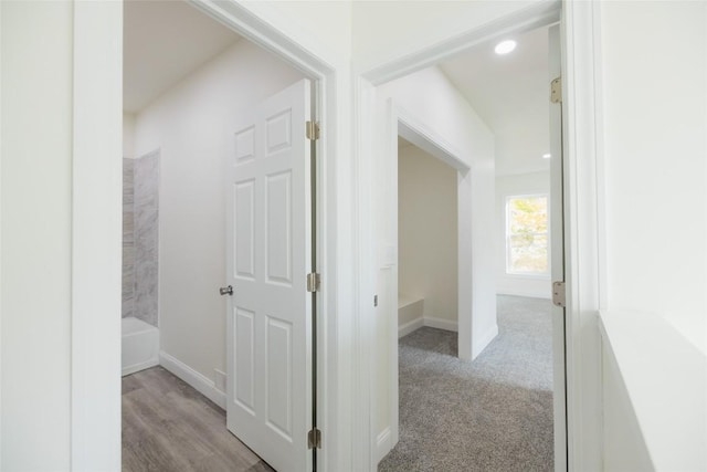 hallway featuring light carpet