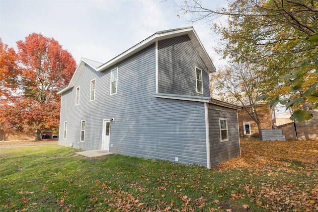 view of side of home with a lawn