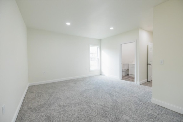 unfurnished room featuring light carpet