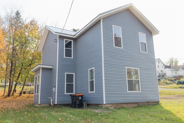 rear view of house with a yard