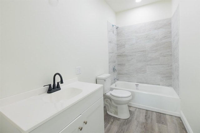 full bathroom with vanity, hardwood / wood-style flooring, toilet, and tiled shower / bath