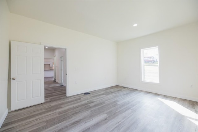 spare room featuring light hardwood / wood-style floors