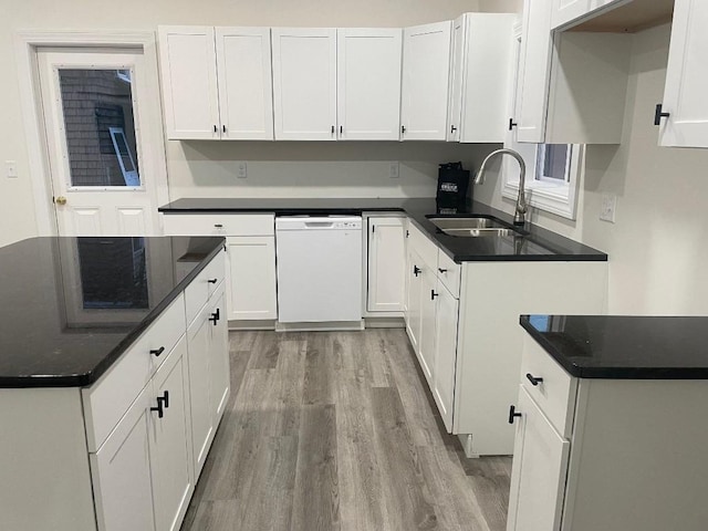 kitchen featuring white cabinets, sink, white dishwasher, and light wood-type flooring