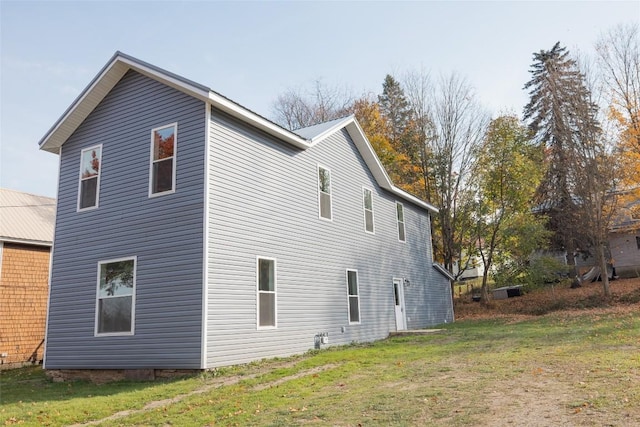 view of home's exterior with a yard