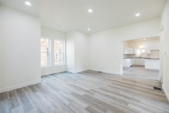 unfurnished living room featuring light wood-type flooring