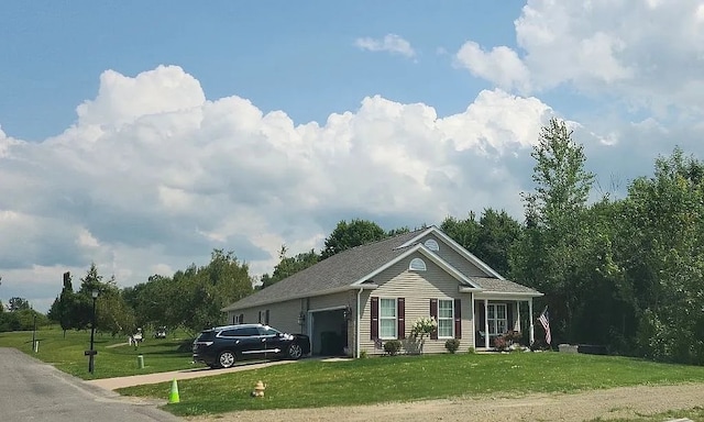 view of front facade with a front lawn, a garage, and concrete driveway
