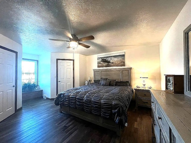bedroom with a textured ceiling, ceiling fan, baseboards, and dark wood-type flooring