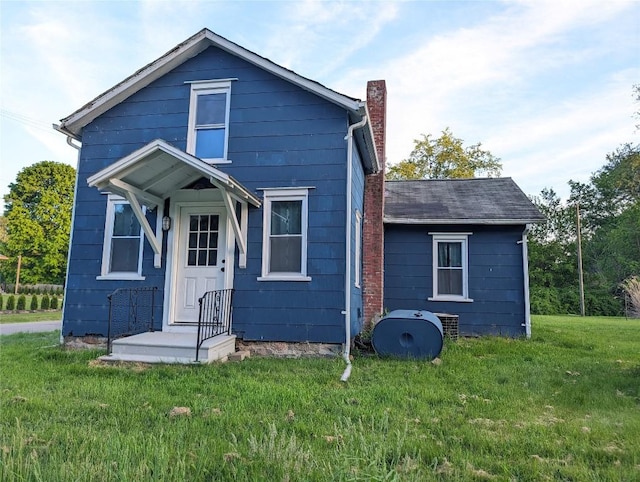 rear view of property featuring a yard