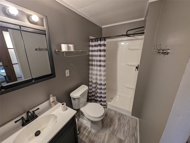 bathroom with a shower with shower curtain, vanity, toilet, and crown molding