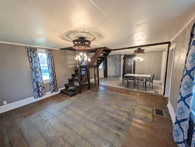 interior space featuring hardwood / wood-style flooring, an inviting chandelier, and ornamental molding