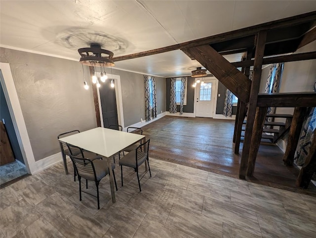 dining room with a chandelier and ornamental molding