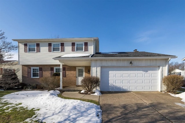 view of front of house featuring a garage and solar panels