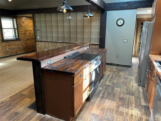 bar with stainless steel appliances, dark wood-type flooring, wooden counters, pendant lighting, and wooden walls