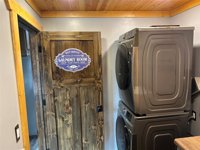 laundry room with stacked washer / drying machine and wood ceiling