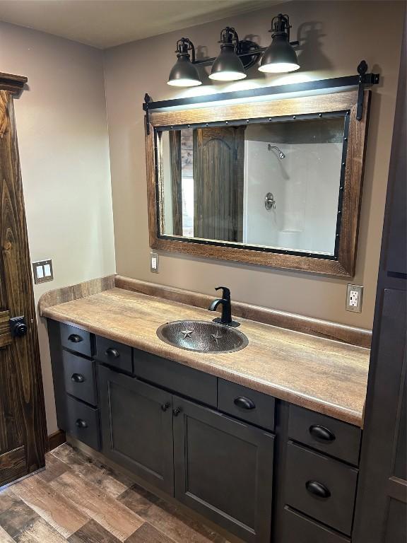 bathroom featuring vanity and wood-type flooring