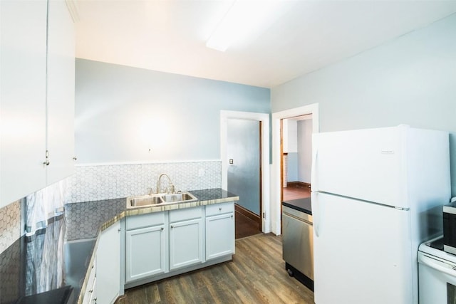 kitchen with tasteful backsplash, sink, white cabinets, dark hardwood / wood-style flooring, and white appliances