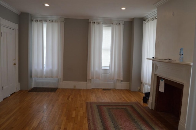 402 Main St, Saegertown, PA 16433 - unfurnished living room with crown molding, light wood-style flooring, recessed lighting, and baseboards