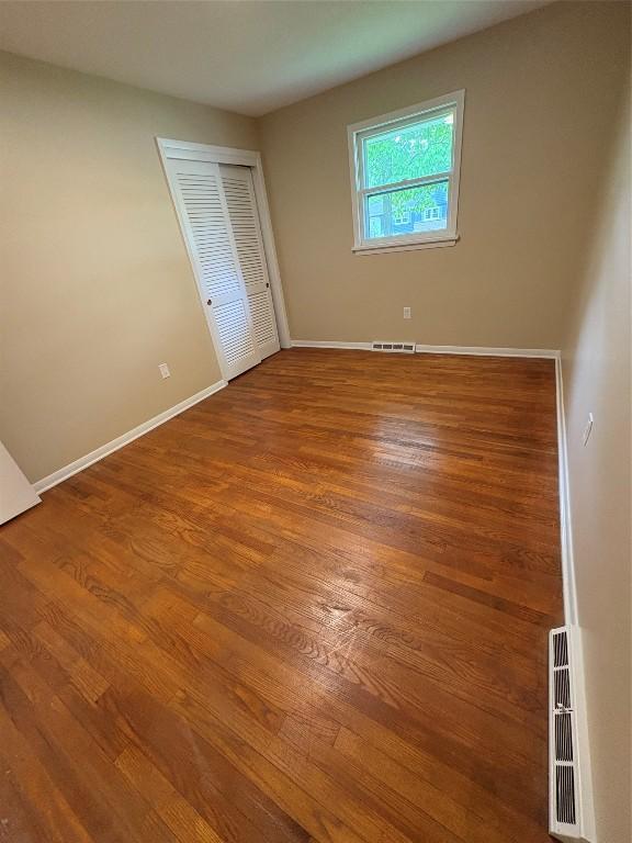 3322 Patio Dr, Millcreek, PA 16506 - unfurnished bedroom featuring baseboards, wood finished floors, and a closet