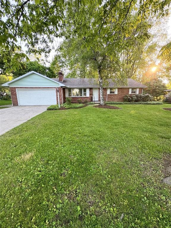 3322 Patio Dr, Millcreek, PA 16506 - ranch-style house with a chimney, driveway, a front yard, brick siding, and a garage