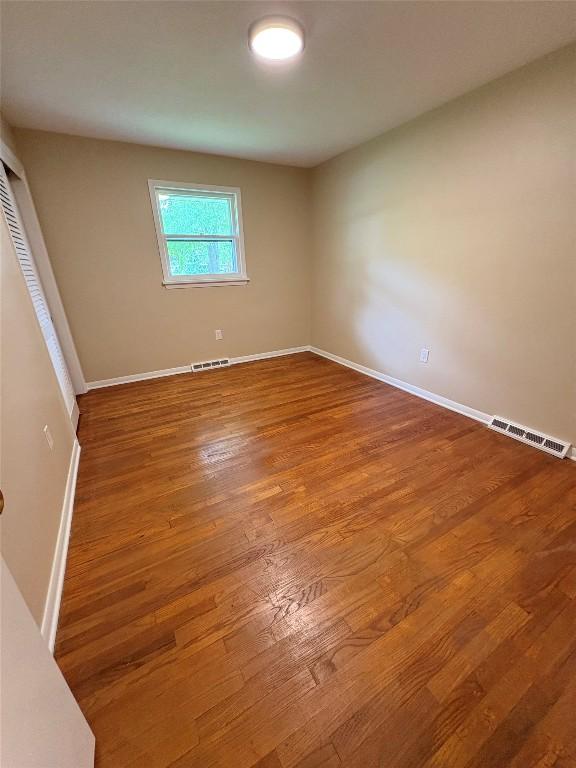 3322 Patio Dr, Millcreek, PA 16506 - empty room with wood finished floors and baseboards