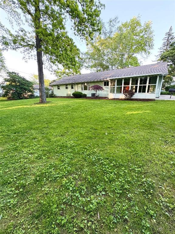 3322 Patio Dr, Millcreek, PA 16506 - rear view of property featuring a sunroom and a lawn