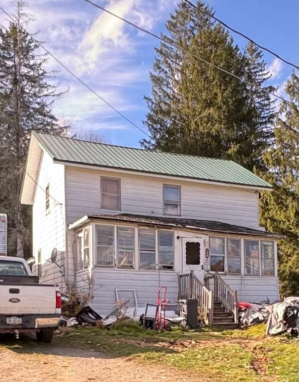 back of property with a sunroom