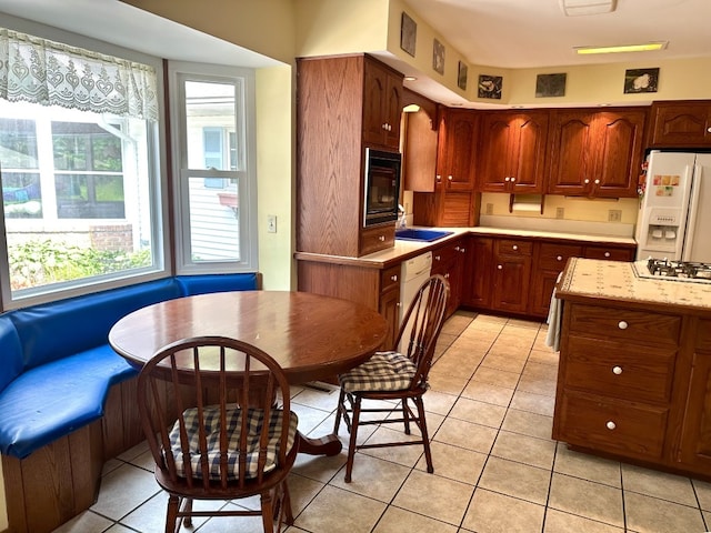 99 N Forest Ave, Meadville, PA 16335 - kitchen featuring white appliances, light tile patterned flooring, and breakfast area
