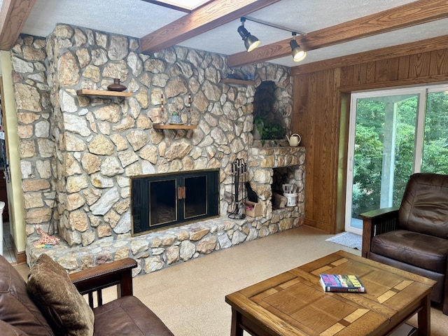 99 N Forest Ave, Meadville, PA 16335 - living room featuring beam ceiling, a stone fireplace, wood walls, and a textured ceiling