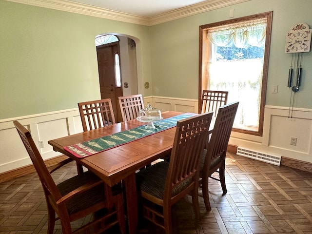 99 N Forest Ave, Meadville, PA 16335 - dining space featuring wainscoting, arched walkways, crown molding, and a decorative wall