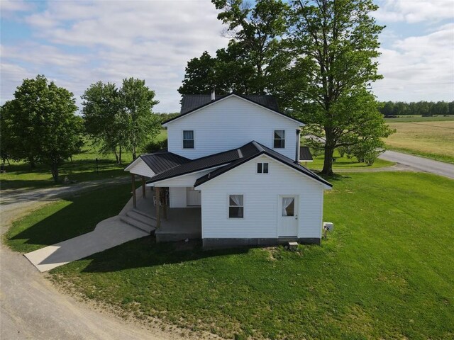 15916 Airport Rd, Linesville, PA 16424 - view of front of house with a front yard, covered porch, and metal roof