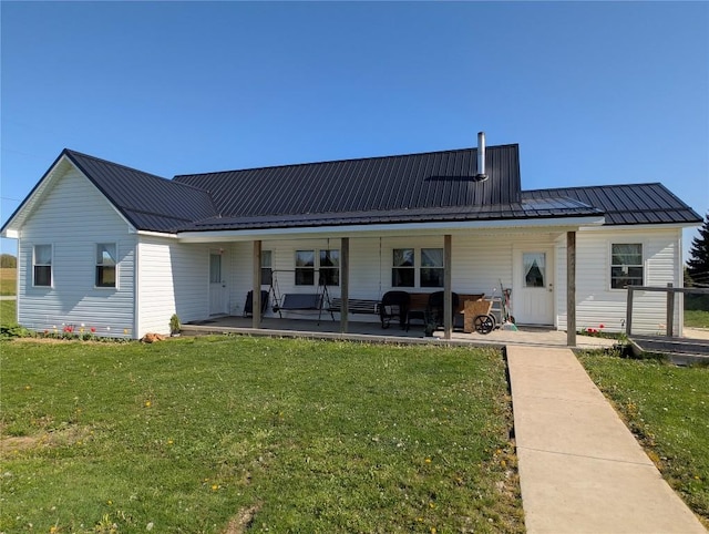 15916 Airport Rd, Linesville, PA 16424 - rear view of house with a yard, metal roof, and a porch